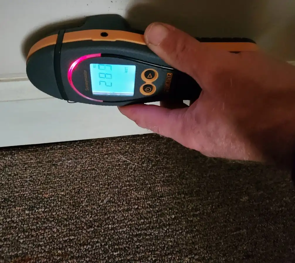 Moisture detection at baseboard during Storm Damage Restoration in Deerfield Beach